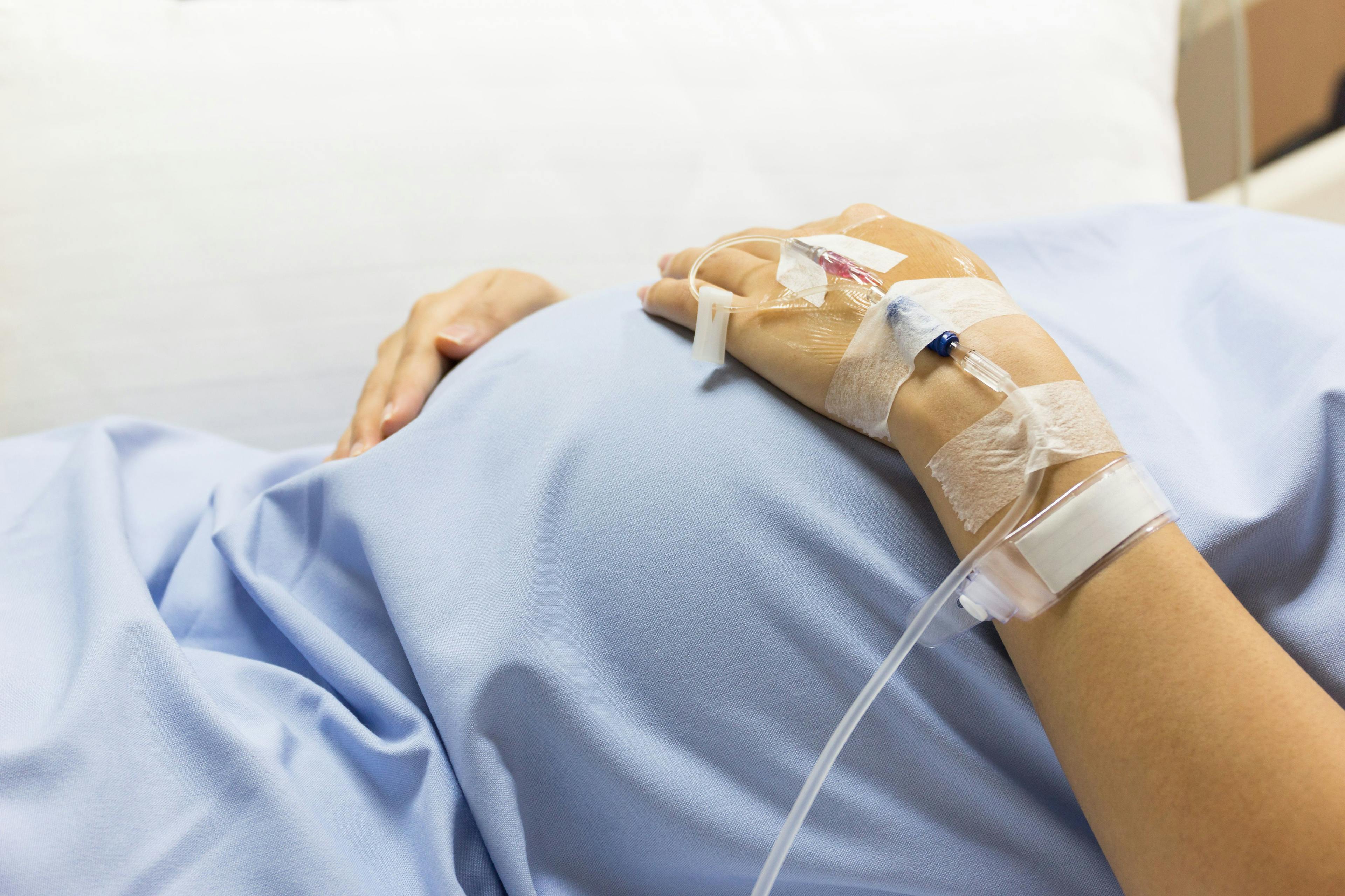 pregnant woman in hospital bed with IV iron anemia